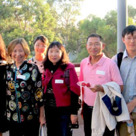 Faculty and international scholars at an event at the Gevirtz School