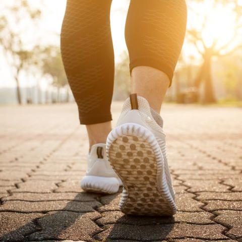 close-up of feet running on road