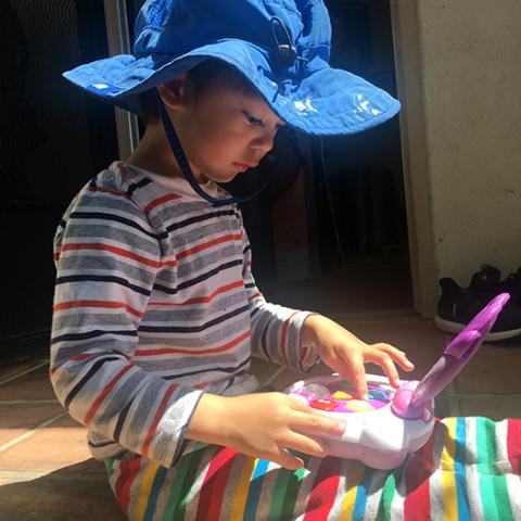 child working on toy computer